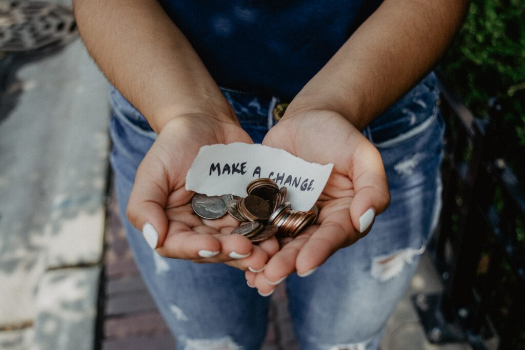 Image shows hands with a note that says make a change